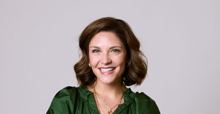 Woman in green shirt smiling at Rochford Orthodontics.
