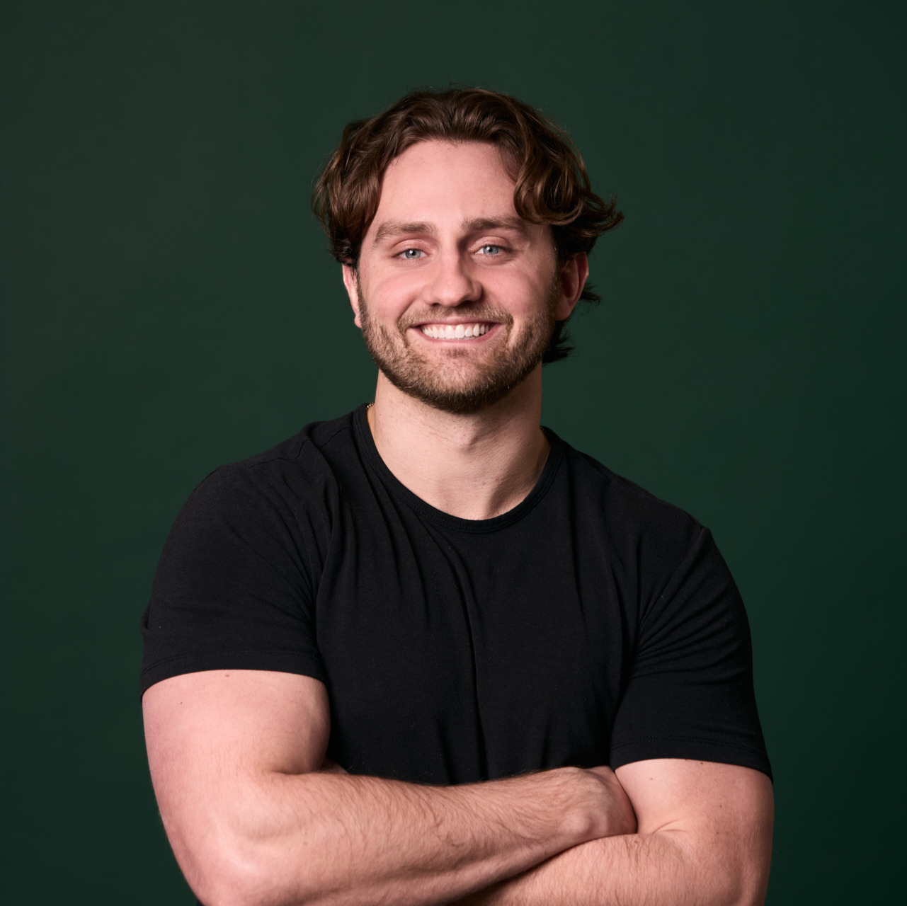 Man smiling and crossing his arms at Rochford Orthodontics.
