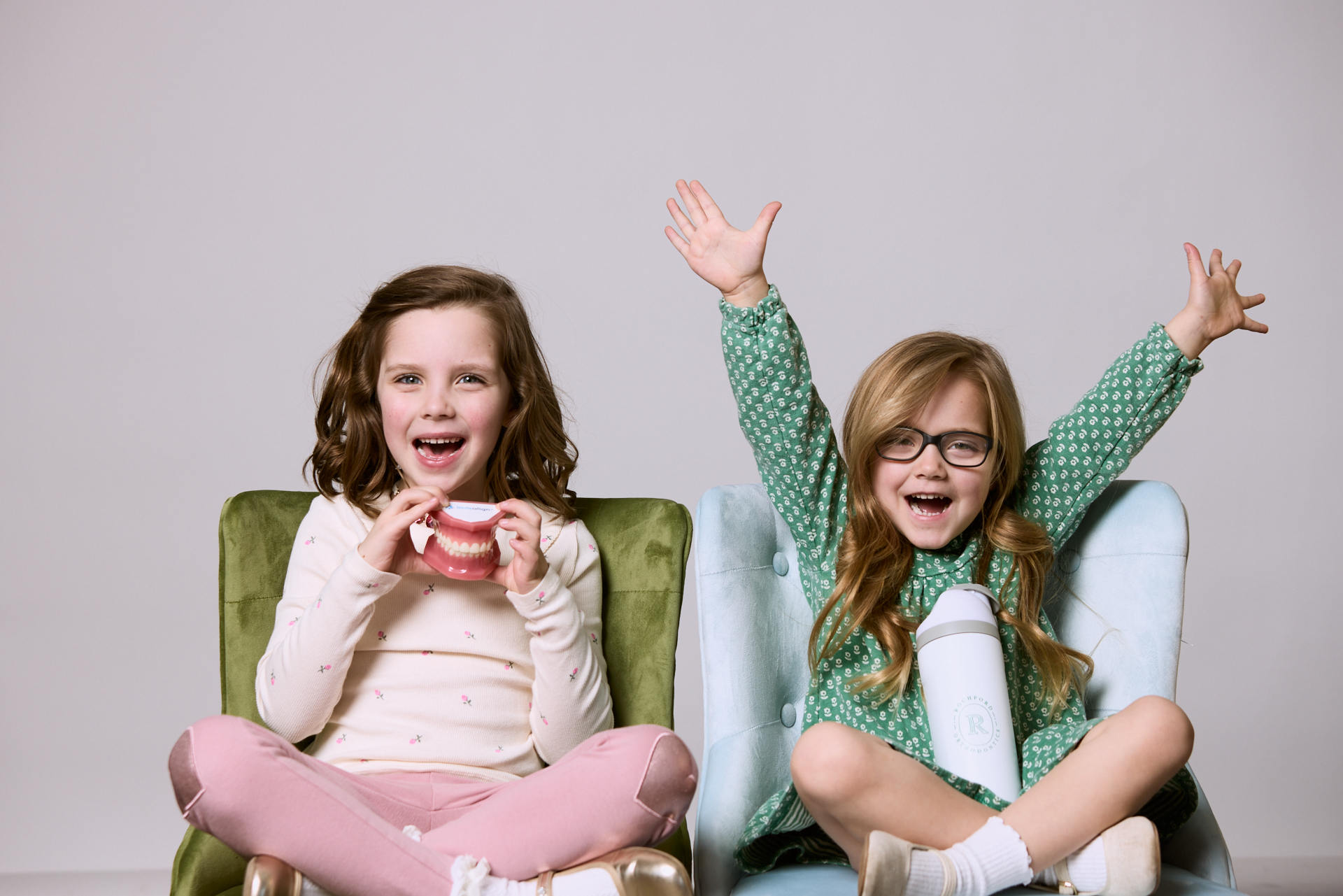 Two little girls smiling at Rochford Orthodontics.