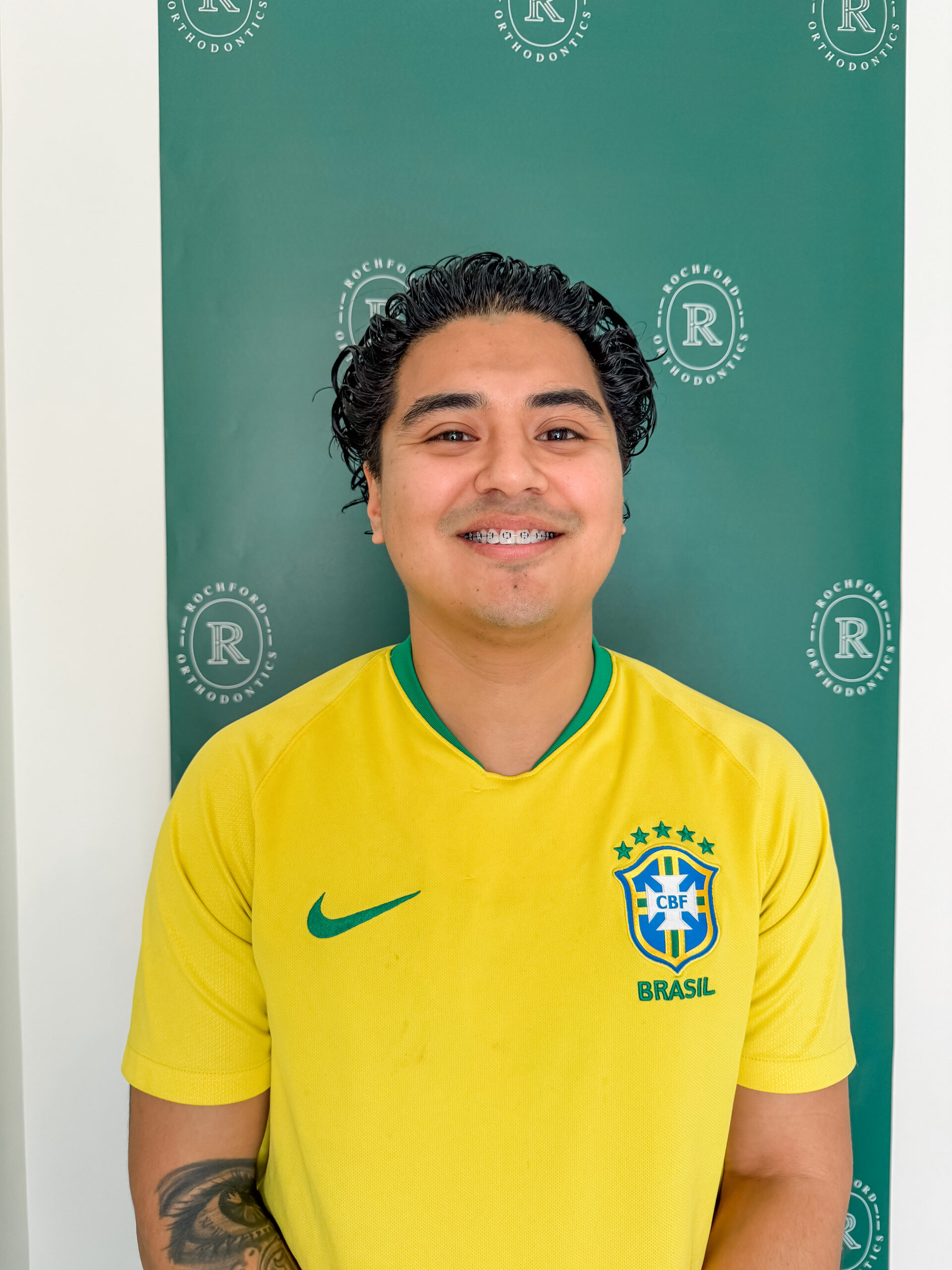Young man smiling with braces at Rochford Orthodontics.