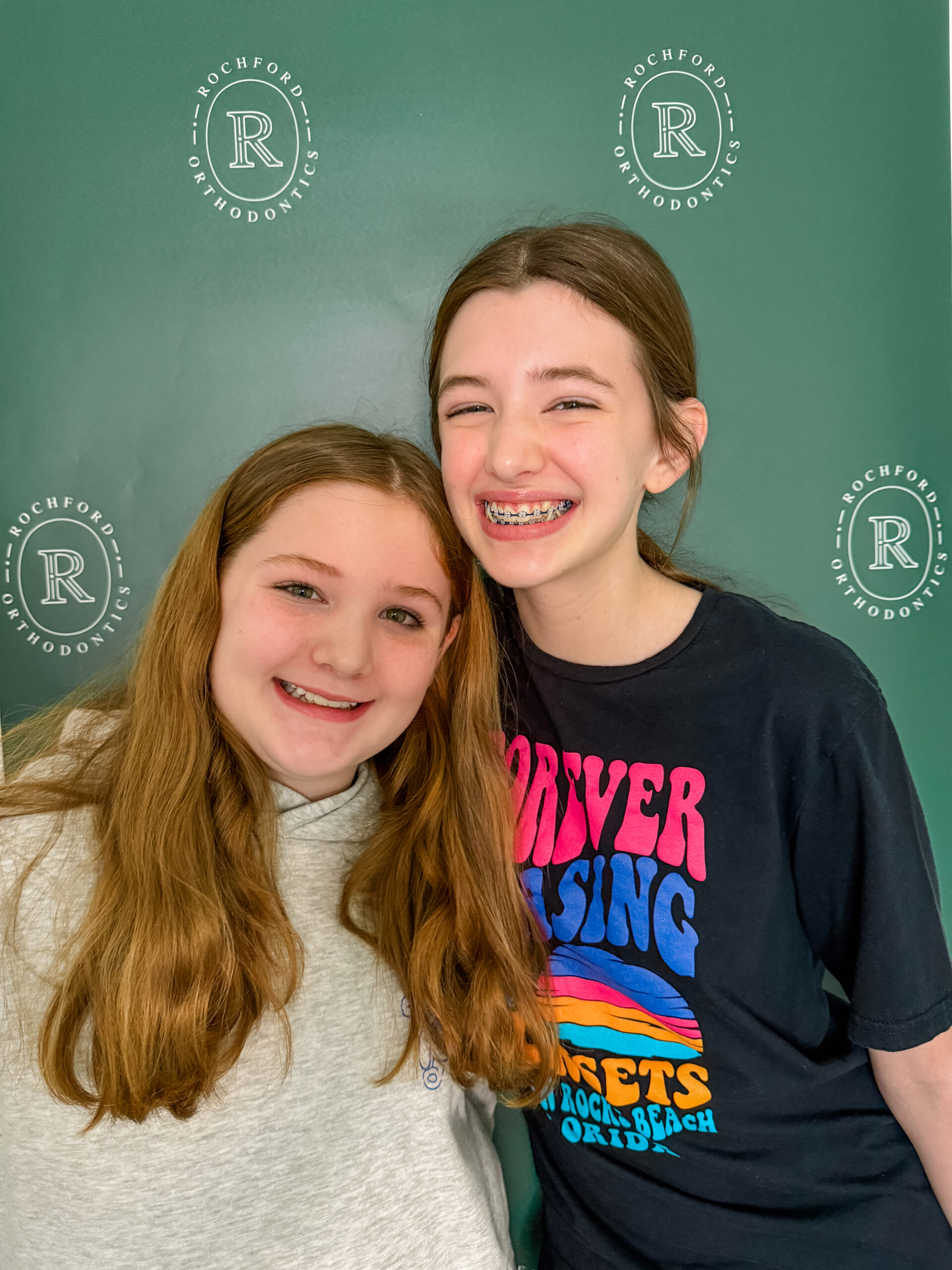 Two smiling girls with braces at Rochford Orthodontics.