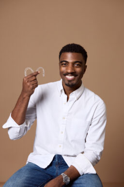 Man holding Invisalign trays at Rochford Orthodontics.