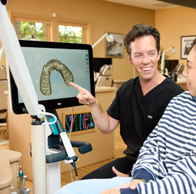 Doctor with patient looking at virtual scan of teeth at Rochford Orthodontics.